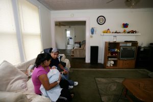 A Hispanic couple at home with their newborn infant. MedVerse - Hablamos Juntos